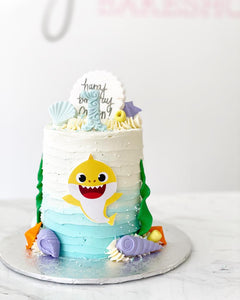 4" round, white to blue buttercream, with baby shark accents