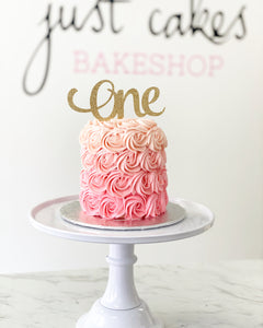 Size: 4" round. Ombre pink buttercream. TOPPERS ARE NOT PROVIDED BY JCB