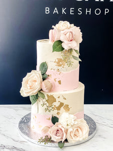 Size: 6-8" two tier. Icing exterior: white. Accent: white, pink.