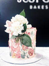 Load image into Gallery viewer, Size: 6&quot; one tier. Icing exterior: white. Accents: white, greens, pinks.
