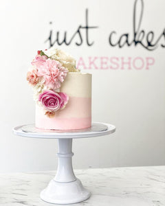 Size: 6" one tier. Icing Exterior: ombre white to pink.